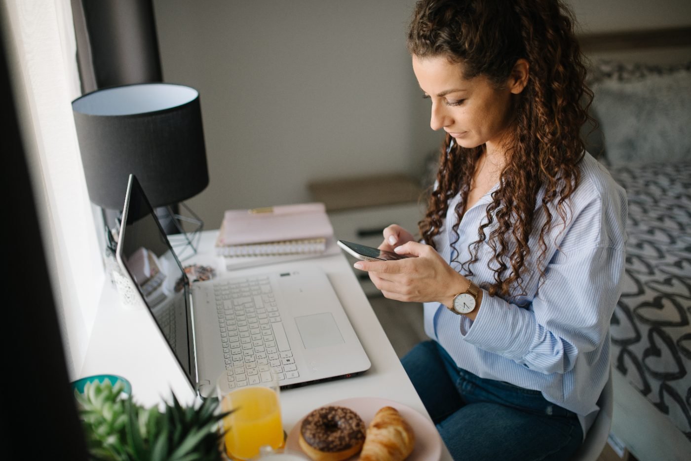 Woman using mobile internet on smartphone at home