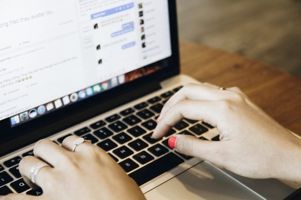 Student typing a question into an AI chatbot on a laptop