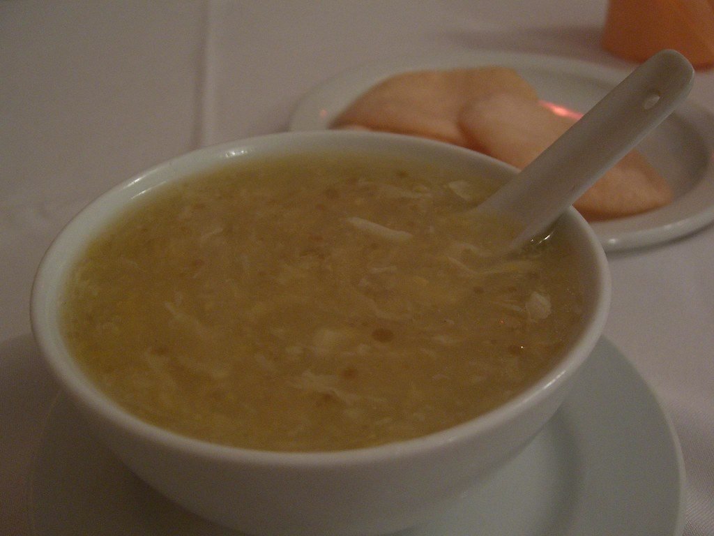 Bowl of chicken corn soup with egg ribbons
