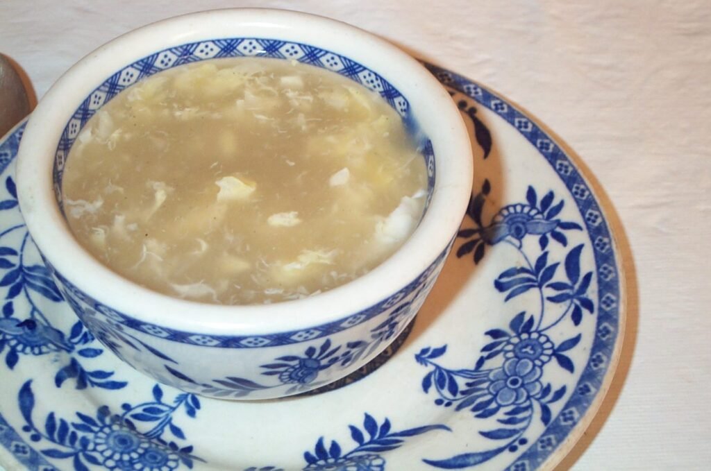 Egg ribbons in thick corn soup in a bowl