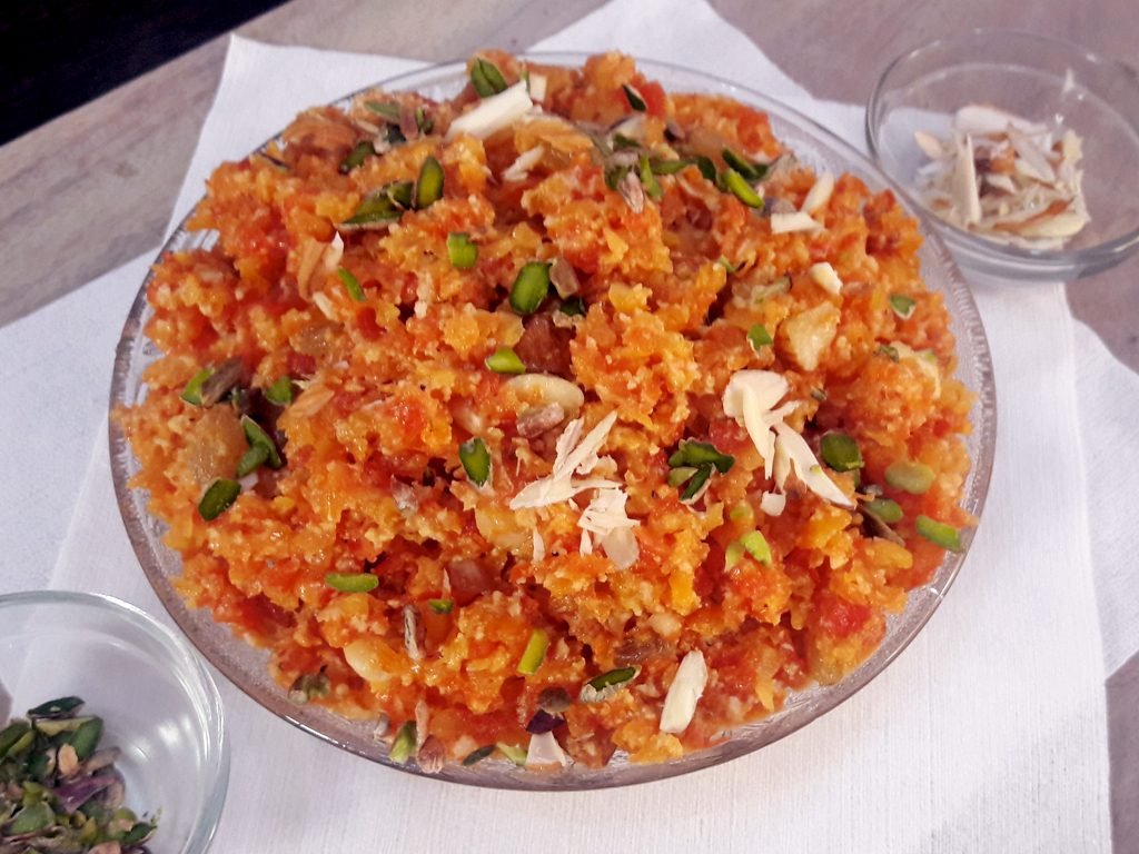 Gajar ka halwa garnished with dry fruits in a bowl