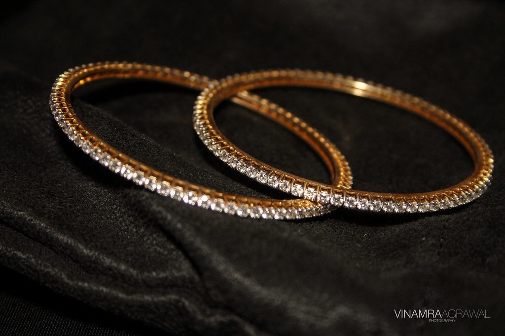 Pair of gold bangles on black cloth