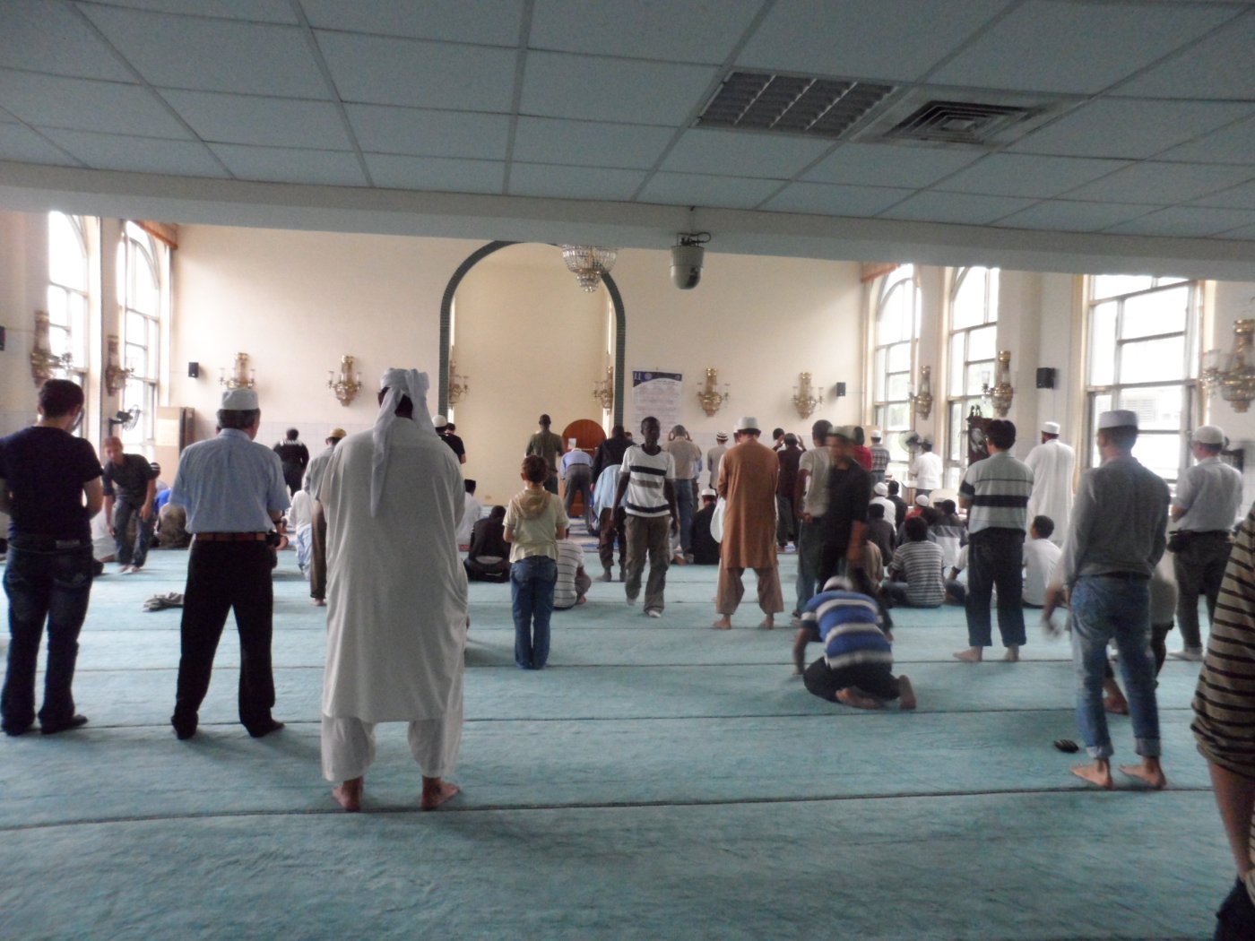 Muslims praying in a mosque prayer hall