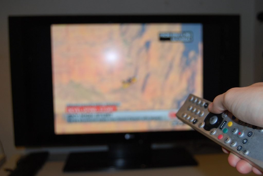 Watching TV drama with remote control in hand